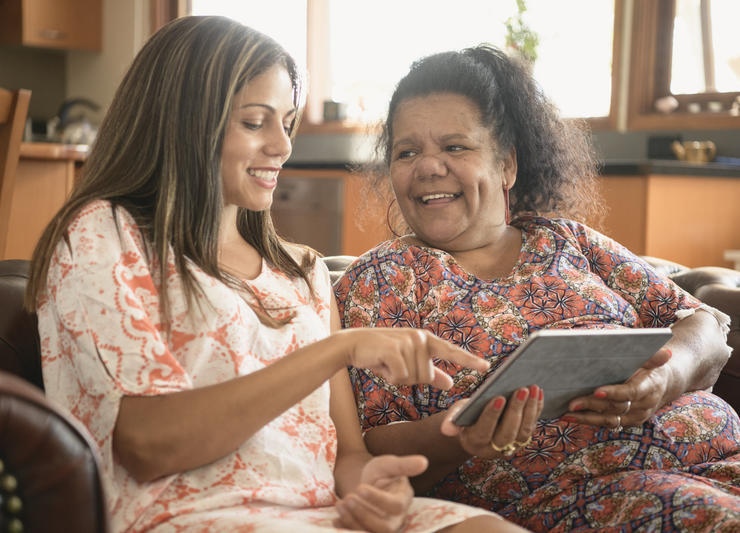 Two women talking with tablet